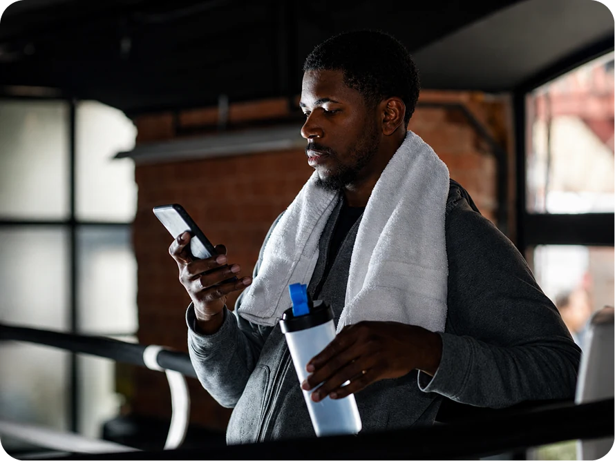 A fitness client checking a subscription on his phone